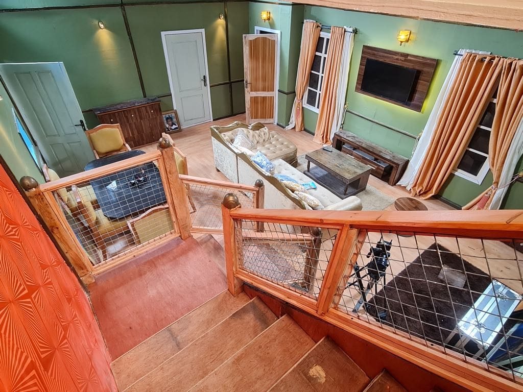 Looking down the staircase of the house set into the sitting room